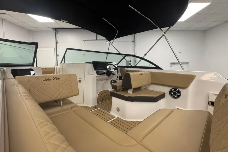 Slide: The Image of 2026 Sea Ray SDX 230 Outboard interior with tan seating and modern dashboard. - 12