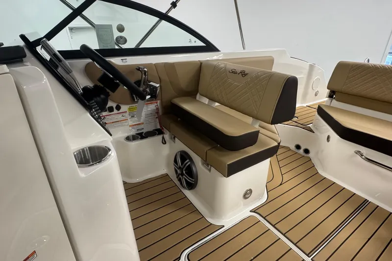 Slide: The Image of 2026 Sea Ray SDX 230 Outboard interior with tan seating and modern dashboard. - 17