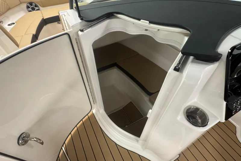 Slide: The Image of 2026 Sea Ray SDX 230 Outboard boat interior with open storage compartment. - 21