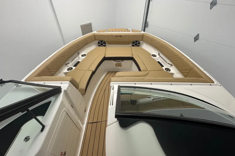 Slide: The Image of 2026 Sea Ray SDX 230 Outboard boat interior with tan seating and cup holders. - 25