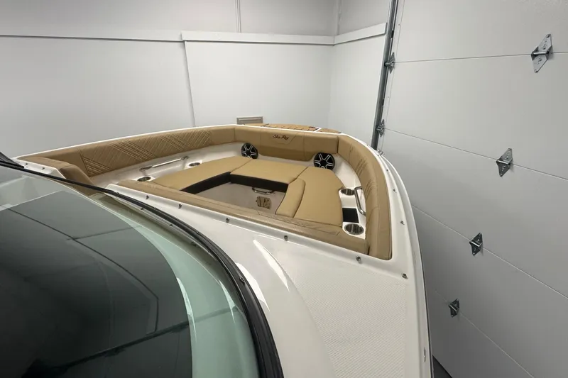 Slide: The Image of 2026 Sea Ray SDX 230 Outboard boat interior with tan seating and cup holders. - 26
