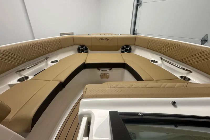 Slide: The Image of 2026 Sea Ray SDX 230 Outboard boat interior with tan seating and cup holders. - 27