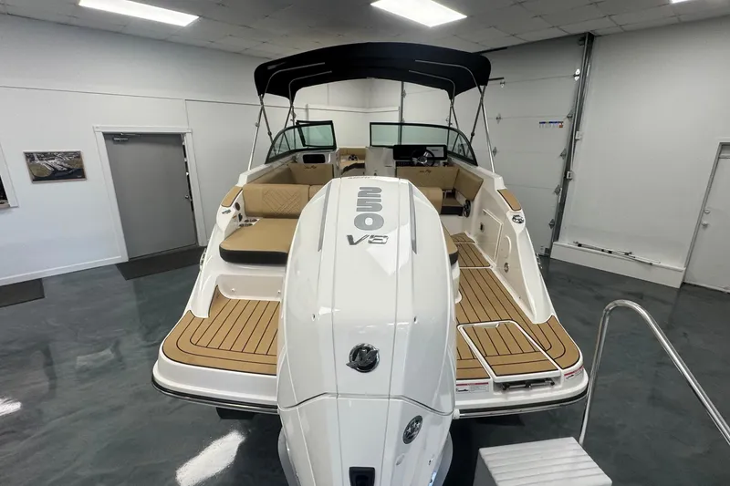 Slide: The Image of 2026 Sea Ray SDX 230 Outboard boat in showroom, featuring spacious deck and modern design. - 5