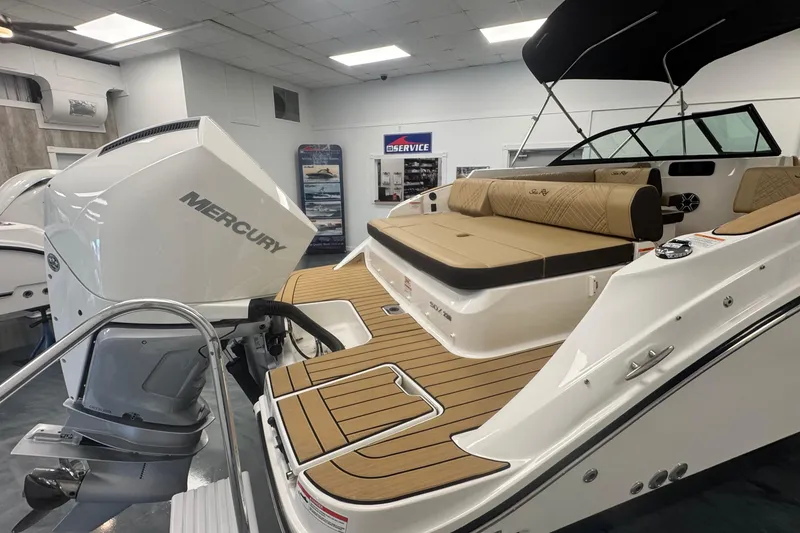 Slide: The Image of 2026 Sea Ray SDX 230 Outboard boat with Mercury engine in showroom. - 6