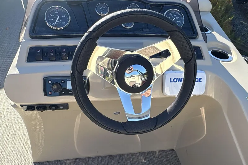 Slide: The Image of Steering wheel and dashboard of 2020 Godfrey Marine 22 boat, featuring gauges and controls. - 10
