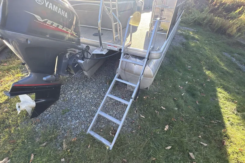 Slide: The Image of 2020 Godfrey Marine 22 boat with Yamaha engine and boarding ladder on grass. - 16