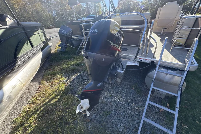 Slide: The Image of 2020 Godfrey Marine 22 pontoon boat with Yamaha outboard motor, parked on gravel. - 4