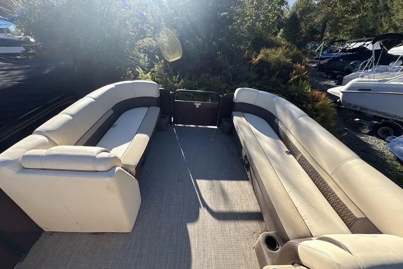 Slide: The Image of 2020 Godfrey Marine 22 pontoon boat interior with beige seating and outdoor setting. - 7