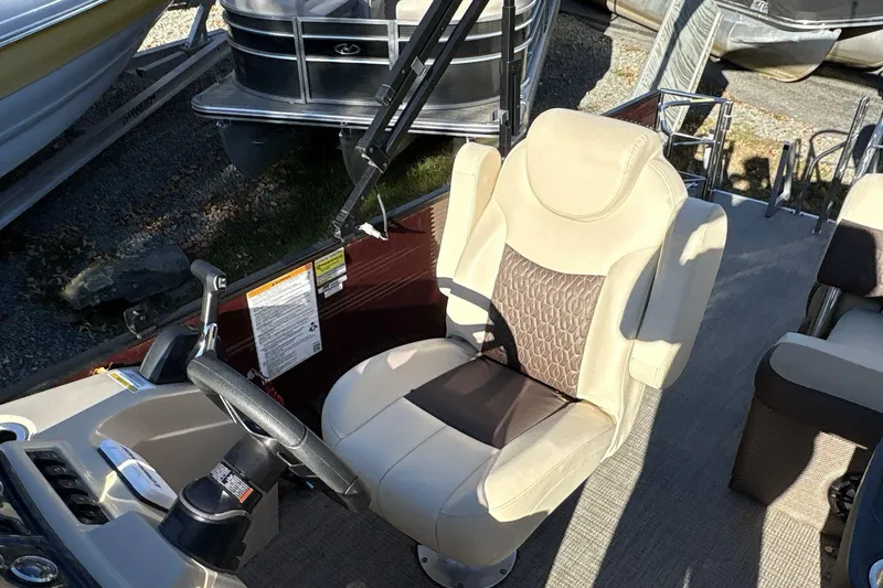 Slide: The Image of Captain's seat on a 2020 Godfrey Marine 22 boat, featuring beige and brown upholstery. - 8