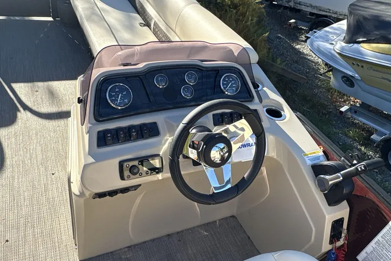 Slide: The Image of 2020 Godfrey Marine 22 boat dashboard with steering wheel and gauges. - 9
