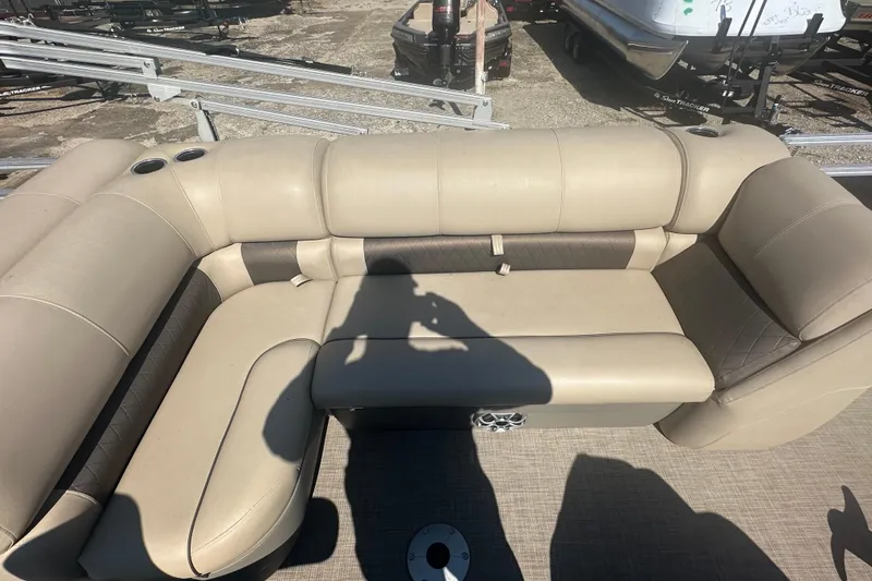 Slide: The Image of 2024 Sun Tracker Fishin' Barge 22 DLX, beige seating area with cup holders. - 14
