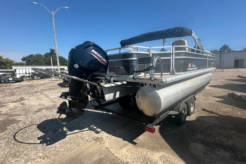 Slide: The Image of 2024 Sun Tracker Fishin' Barge 22 DLX pontoon boat with Mercury engine on trailer. - 4