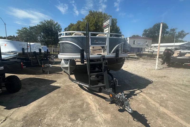 Slide: The Image of 2024 Sun Tracker Fishin' Barge 22 DLX pontoon boat on trailer in outdoor lot. - 5