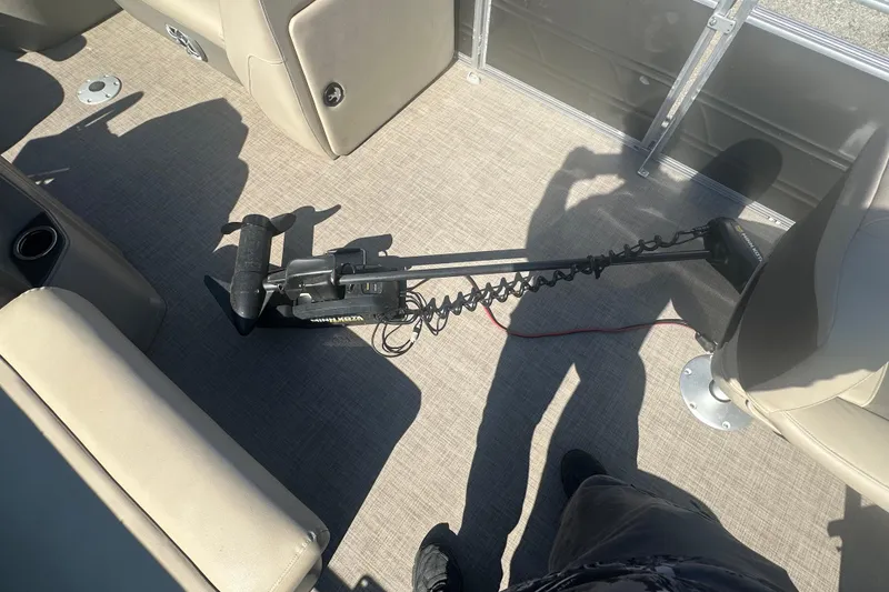 Slide: The Image of 2024 Sun Tracker Fishin' Barge 22 DLX interior with trolling motor and seating. - 7