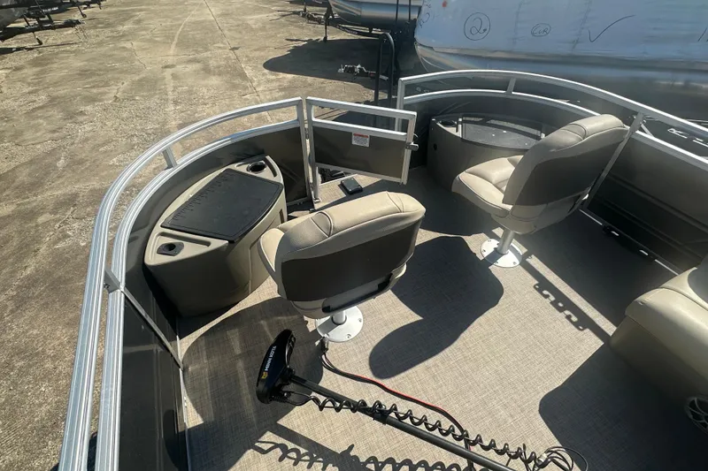 Slide: The Image of 2024 Sun Tracker Fishin' Barge 22 DLX interior with seating and fishing equipment. - 8