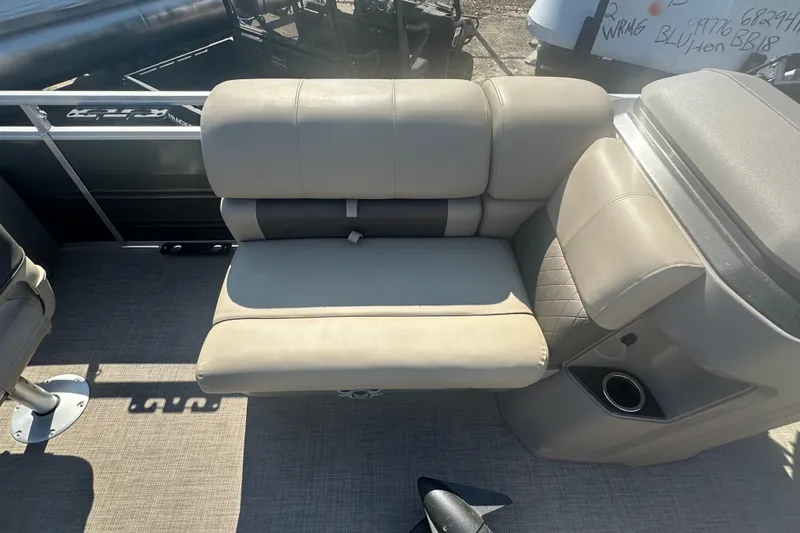 Slide: The Image of 2024 Sun Tracker Fishin' Barge 22 DLX interior seating with cup holder and storage. - 9