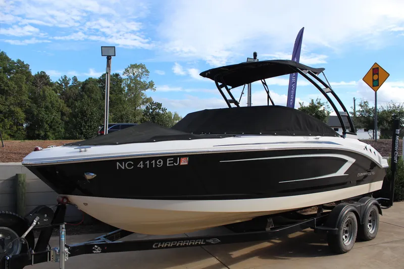 Slide: The Image of 2018 Chaparral 21 H2O Sport boat on trailer, covered and parked outdoors. - 1