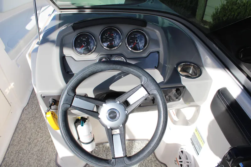 Slide: The Image of 2018 Chaparral 21 H2O Sport boat dashboard with steering wheel and gauges. - 12