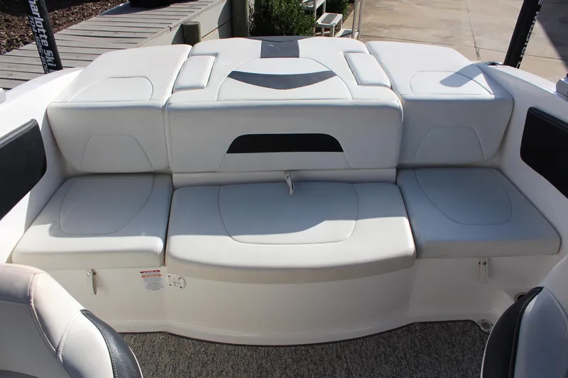 Slide: The Image of 2018 Chaparral 21 H2O Sport boat interior with white cushioned seating. - 14