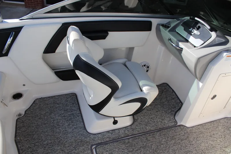 Slide: The Image of 2018 Chaparral 21 H2O Sport boat interior with sleek captain's chair and modern dashboard. - 15