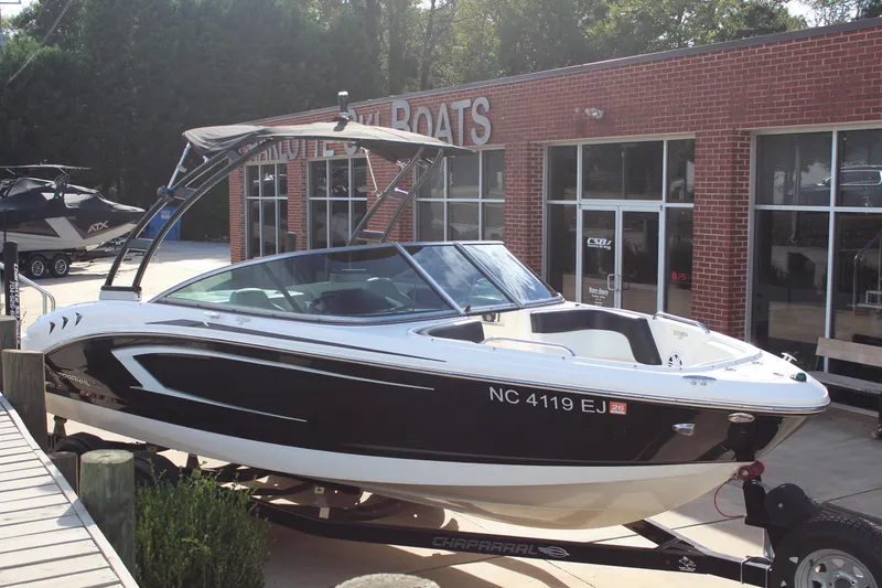 Slide: The Image of 2018 Chaparral 21 H2O Sport boat displayed outside a dealership. - 3