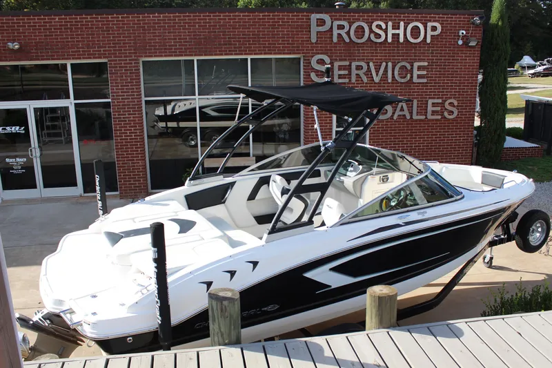 Slide: The Image of 2018 Chaparral 21 H2O Sport boat displayed outside a pro shop. - 5