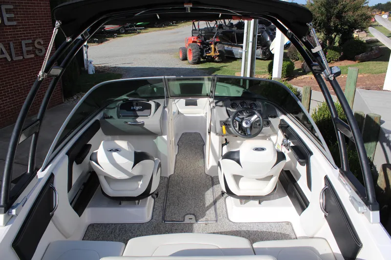 Slide: The Image of 2018 Chaparral 21 H2O Sport boat interior with seating and steering wheel. - 8