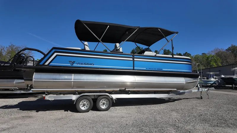 Slide: The Image of 2025 Viaggio Z24Q pontoon boat on trailer, featuring blue and silver design with canopy. - 3