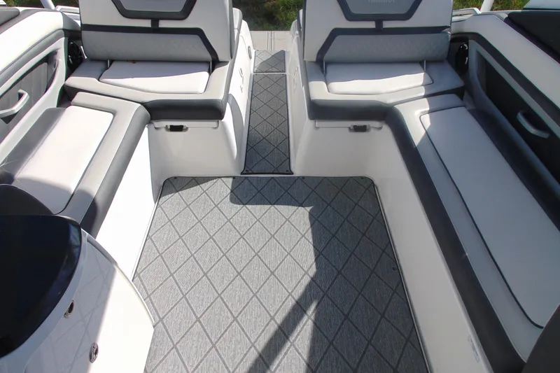 Slide: The Image of 2019 Yamaha Boats 275SD interior with cushioned seating and diamond-patterned flooring. - 11