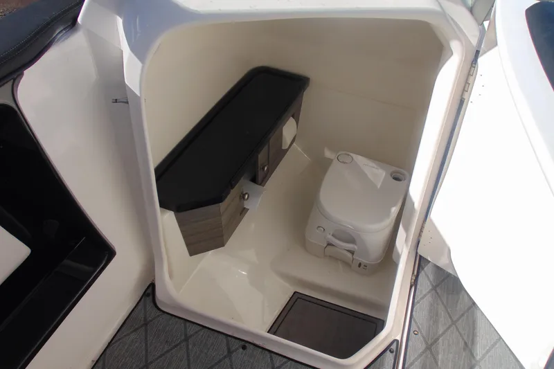 Slide: The Image of 2019 Yamaha Boats 275SD interior with compact marine toilet and storage cabinet. - 12