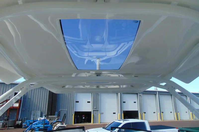 Slide: The Image of 2019 Yamaha Boats 275SD with a sleek, modern sunroof design in a marina setting. - 17