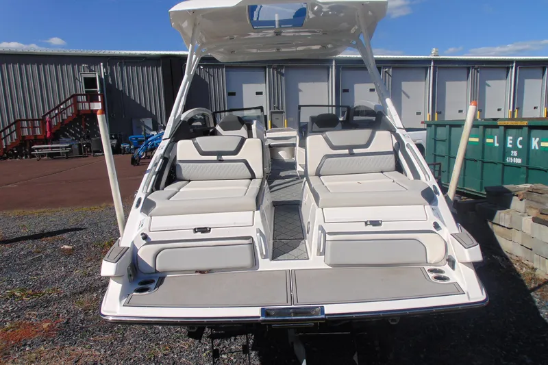 Slide: The Image of 2019 Yamaha Boats 275SD with dual seating, docked outdoors. - 4