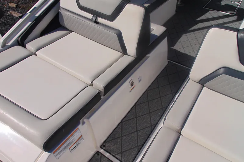 Slide: The Image of 2019 Yamaha Boats 275SD interior seating with cushioned upholstery and diamond-patterned flooring. - 6