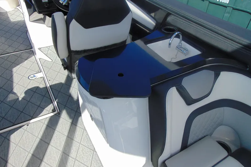 Slide: The Image of 2019 Yamaha Boats 275SD interior with sleek seating and compact sink area. - 8