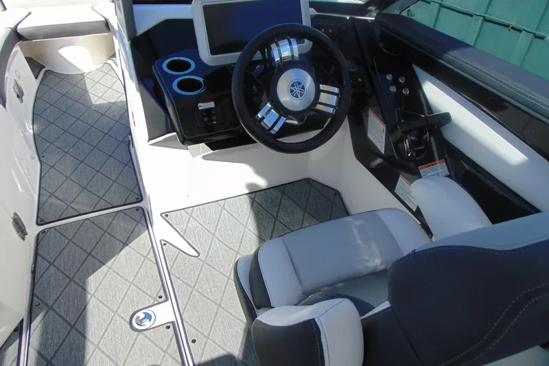 Slide: The Image of 2019 Yamaha Boats 275SD cockpit with steering wheel and seating, featuring modern design. - 9