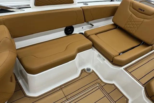 Slide: The Image of 2026 Chaparral 250 OSX boat interior with tan leather seating and sleek design. - 12