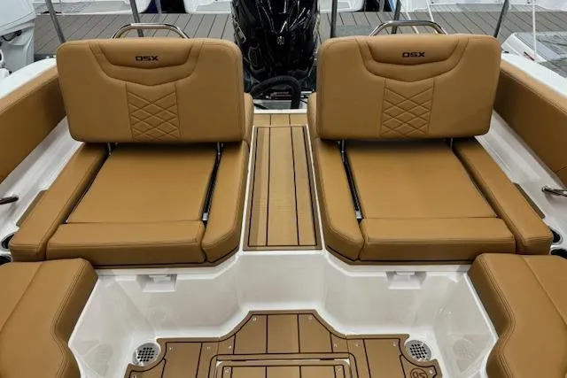 Slide: The Image of 2026 Chaparral 250 OSX boat interior with tan leather seating and white accents. - 13