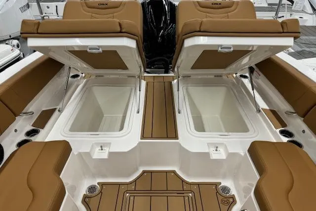 Slide: The Image of 2026 Chaparral 250 OSX boat interior with tan leather seating and teak flooring. - 16