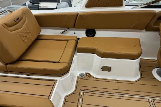Slide: The Image of 2026 Chaparral 250 OSX boat deck with storage compartment and teak-style flooring. - 19