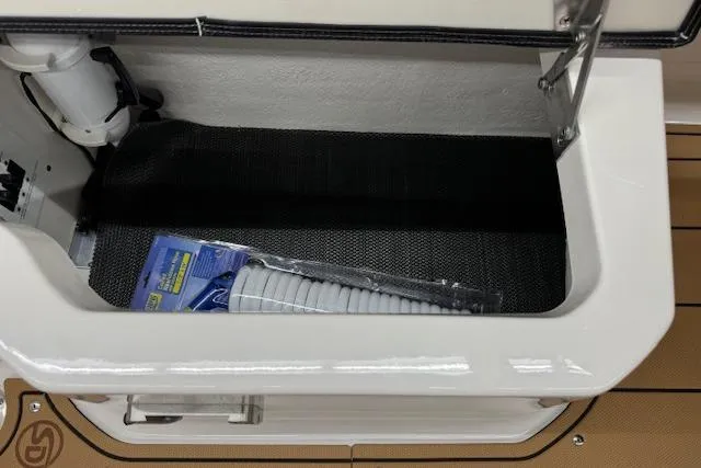 Slide: The Image of 2026 Chaparral 250 OSX boat interior with tan leather seating and teak flooring. - 20