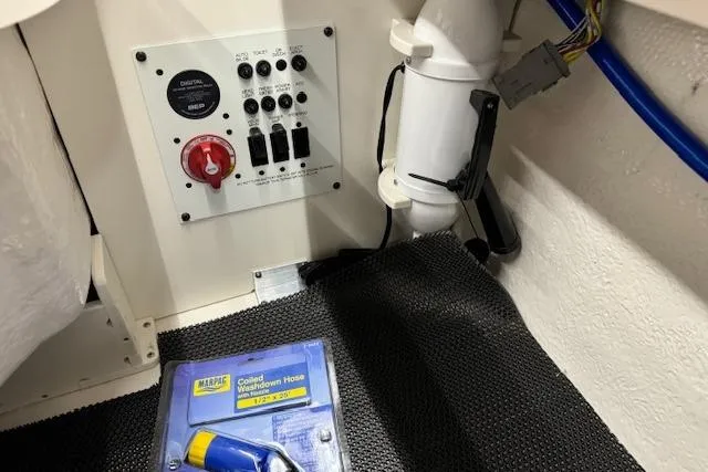 Slide: The Image of Open storage compartment in 2026 Chaparral 250 OSX boat with packaged accessory inside. - 21