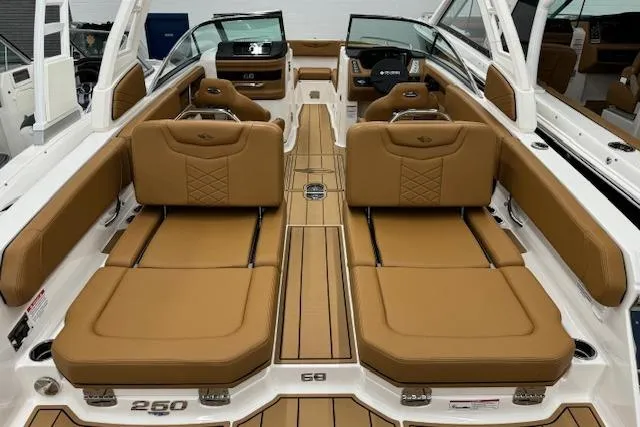 Slide: The Image of Control panel and coiled washdown hose in 2026 Chaparral 250 OSX boat interior. - 22