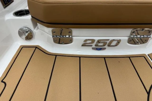 Slide: The Image of 2026 Chaparral 250 OSX boat deck with tan seating and sleek design. - 25