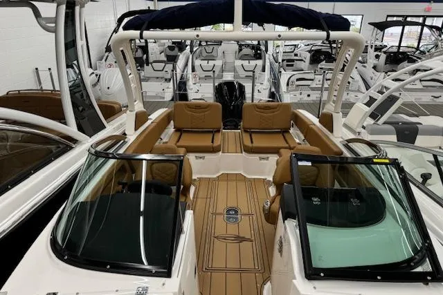 Slide: The Image of 2026 Chaparral 250 OSX boat interior with tan seating and modern design. - 3