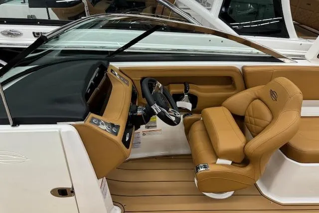 Slide: The Image of 2026 Chaparral 250 OSX boat interior with tan leather seating and modern dashboard. - 5