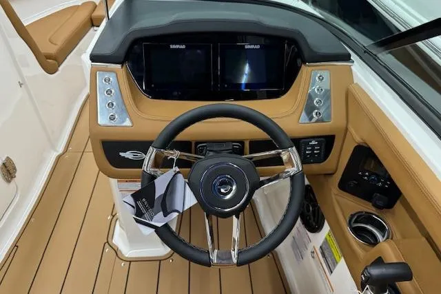 Slide: The Image of 2026 Chaparral 250 OSX boat interior with tan leather seating and modern dashboard. - 6