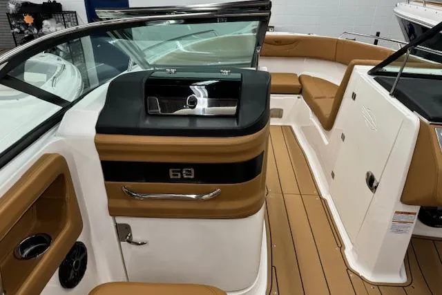Slide: The Image of 2026 Chaparral 250 OSX boat interior with tan seating and modern dashboard. - 8