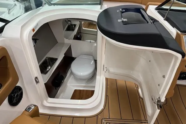 Slide: The Image of 2026 Chaparral 250 OSX boat interior with tan seating and sleek design. - 9