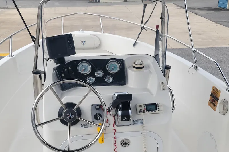 Slide: The Image of 2012 Campion Explorer 492 Center Console dashboard with steering wheel and navigation instruments. - 10