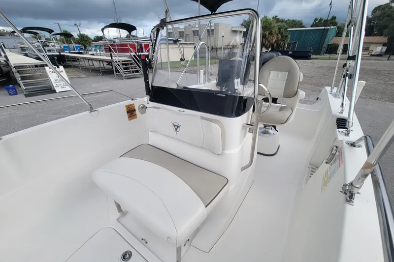 Slide: The Image of 2012 Campion Explorer 492 Center Console boat with seating and steering wheel, parked outdoors. - 13